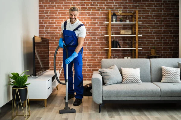depositphotos_501535970-stock-photo-man-uniform-vacuuming-house-floor